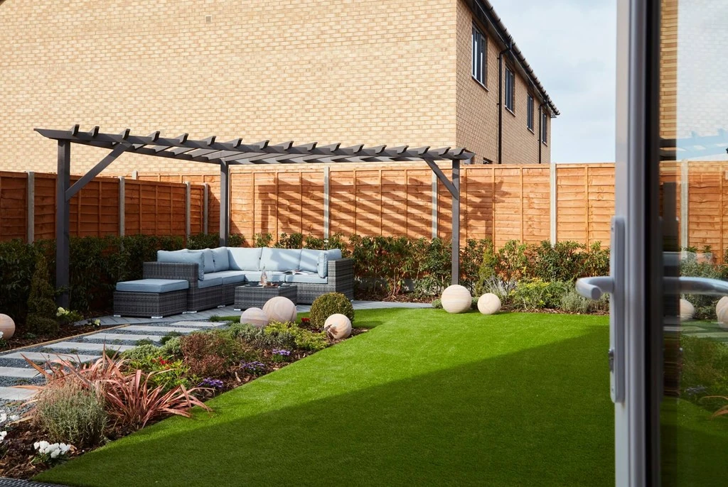 Outdoor seating in a garden under a sunshade